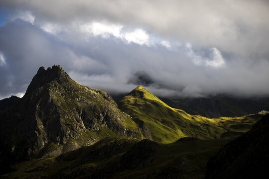 Grassy mountains with light mood and threatening clouds, Tschagguns, R&auml;tikon, Montafon, Vorarlberg, Austria