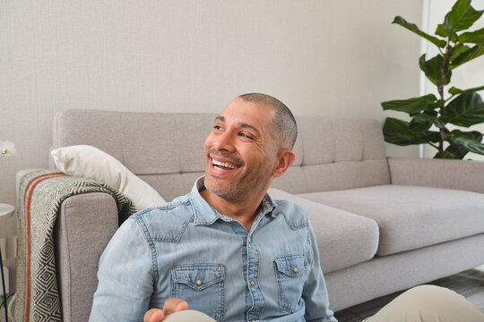 Man laughing with joy and enjoying a relaxing moment at home