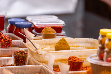 Assortment of various oriental spices on the counter at the Asian bazaar in close-up. Pyramids of spices. Heap different Asian Spices. Spice and seasoning. Assortment spices and herbs for cooking.