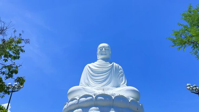Nha Trang, Vietnam - September 18, 2025. Chua Long Son Pagoda with a large white Buddha statue in the vast, clear blue sky. The main Buddhist temple of Kien Giang Province. 4К	