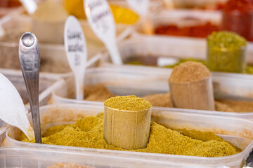 Assortment of various oriental spices on the counter at the Asian bazaar in close-up. Pyramids of spices. Heap different Asian Spices. Spice and seasoning. Assortment spices and herbs for cooking.