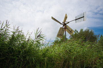 old windmill in tall grass