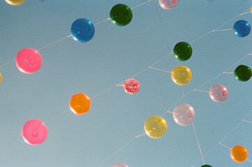colorful plastic balloons hanging in sky
