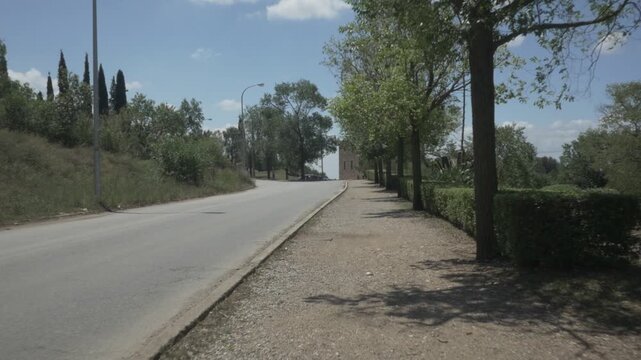 Road street trees dirt pavement gimbal stabilized traveling house Terrassa
