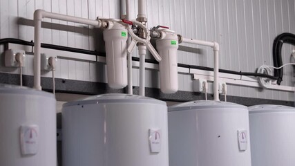 Water filtration system with multiple tanks and pipes, showcasing intricate plumbing details, camera zooming in for a closer view of the components and connections
