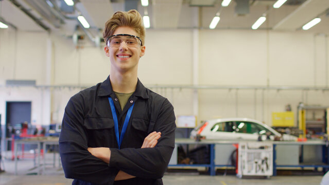 Portrait Of Male Student Wearing Safety Glasses Studying For Auto Mechanic Apprenticeship At College