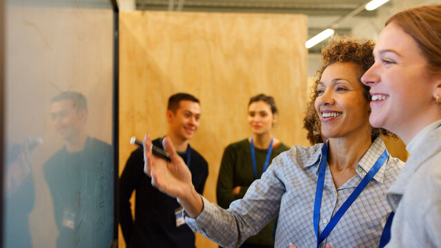 Female Tutor Meeting With Students At College Induction Day - Powered by Adobe