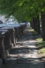 A quiet path along the Griboyedov Canal in St. Petersburg. A harmonious blend of nature and architecture.