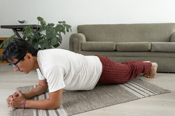 Man doing plank exercise at home for core strength