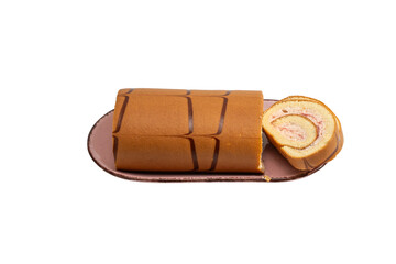 Swiss roll cake on a rectangular plate with one slice served beside, isolated on white. Strawberry cream sponge roll with chocolate stripe decoration.