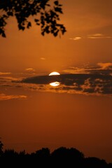 Beautiful summer sunset over the sea and beach, casting an orange and red reflection on the water and clouds