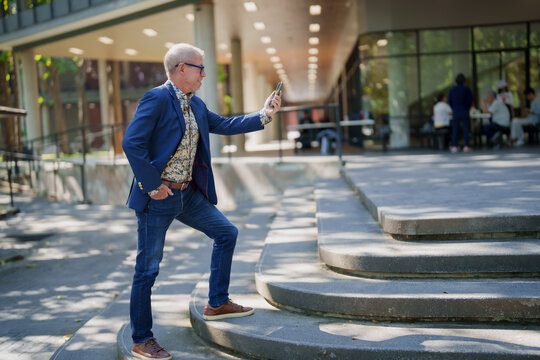 Senior man smiling enjoying city life making a selfie
