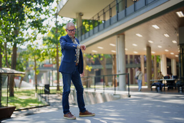 Senior man checking time waiting outdoors business casual