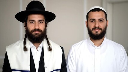 Two bearded men in traditional religious attire, symbolizing unity and diversity