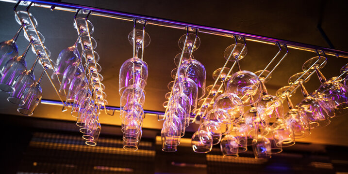 Hanging wine glasses on the bar