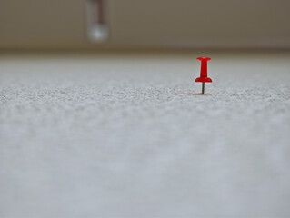 Red pin on white wall abstract backdrop