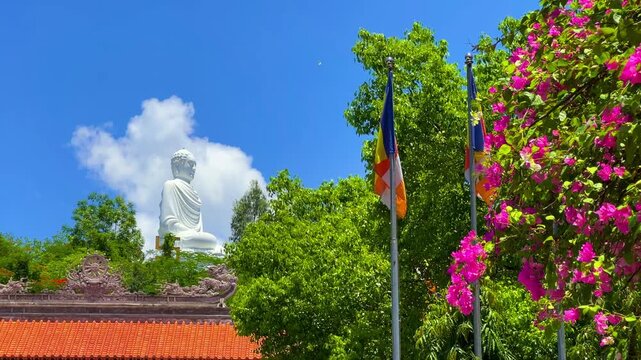 Nha Trang, Vietnam - September 18, 2025. Chua Long Son Pagoda with a large white Buddha statue in the vast, clear blue sky. The main Buddhist temple of Kien Giang Province. 4К	