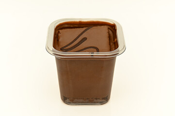 Pieces of swiss roll and knife on cutting board on wooden table