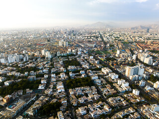 Obraz premium Aerial view of the affluent La Aurora neighborhood in Miraflores, Lima, displaying green parks, organized streets, and modern residential infrastructure.