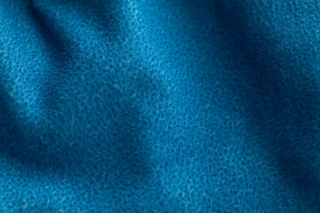 Macro photo of a vibrant blue fleece fabric. The soft, piled texture and gentle folds create a cozy, abstract background for textile or comfort concepts. ©  Colorshadow