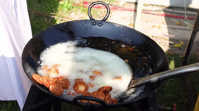 Kachori or khasta being fried in oil at shop in morning