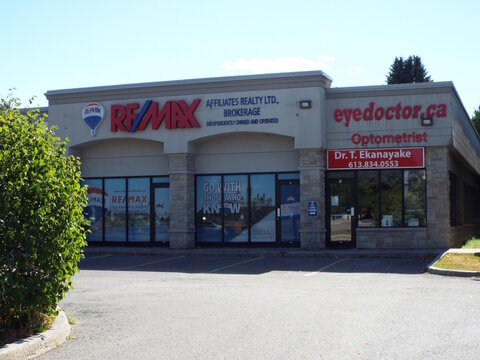  Orleans, ON, Canada-June 27,2025: The exterior of two businesses:  "REMAX real estate brokerage and an optometrist office, eyedoctor.ca"  at 1180 Place d'Orl&eacute;ans Dr.
