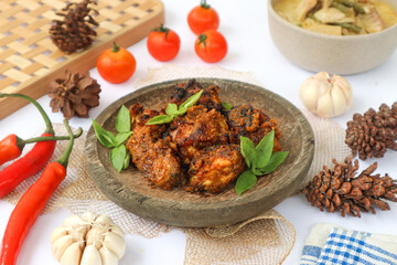 It's a plate of Indonesian charcoal-grilled chicken, or ayam bakar, served with spicy sauce. It's a popular side dish in the country.