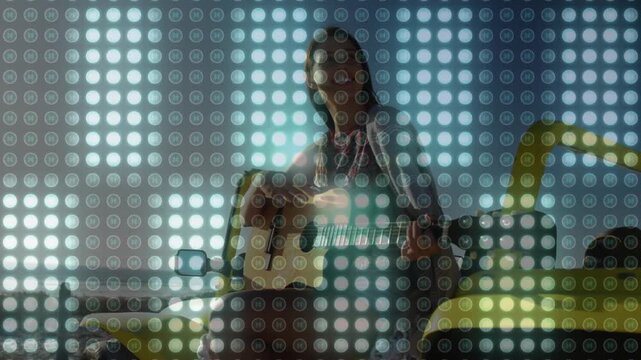 Musician starting with subtle posture shift, strumming guitar by yellow car, overlaying dot grid