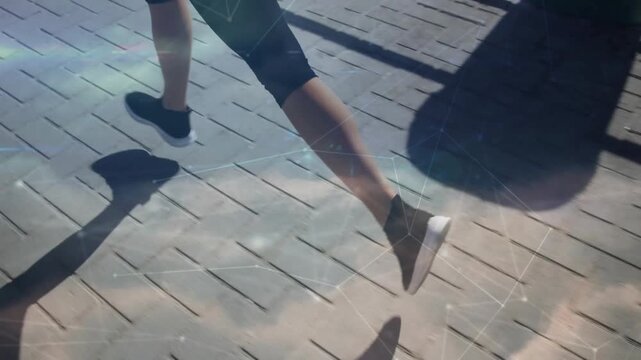 Opening foot contact initiating two runners matching pace across wooden deck, casting long shadows