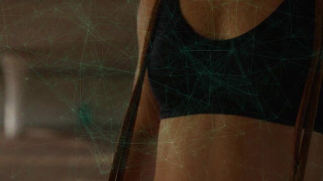 Woman gripping strap drawing up while green overlay appearing straightening and turning for workout