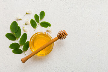 honey jar with acacia flowers and leaves. fresh honey top view flat lay