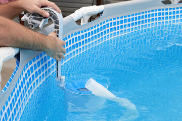 Man cleans skimmer for the frame pool. Contaminated pool cleaning concept