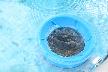Top view of the blue skimmer for cleaning the pool in clear water. Contaminated pool cleaning concept