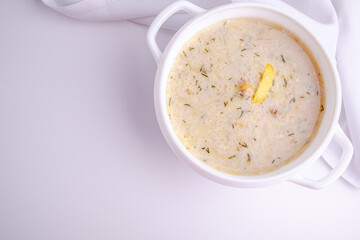 Homemade creamy fish soup with dill on a white background