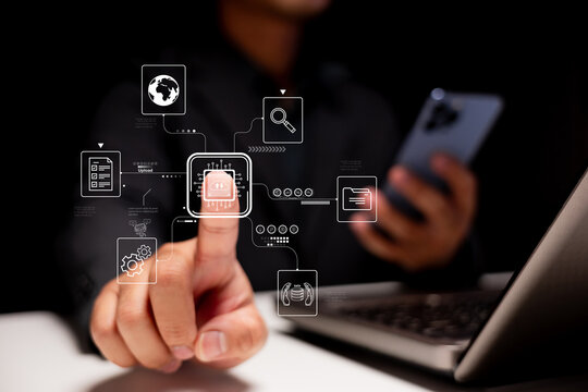 A person interacts with digital interfaces on a smartphone and laptop, showcasing technology and data visualization in a modern setting. - Powered by Adobe