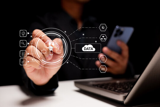 A person interacts with a digital interface displaying data-related icons, emphasizing technology and data management.