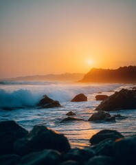 Golden sunset waves crashing on rocky shore beach location nature scene serene environment coastal view