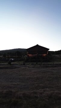 Silhouette of a house at dusk with decorative lights in Mexico dolly out camera movement