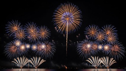Fototapeta premium Fireworks display over dark water at night