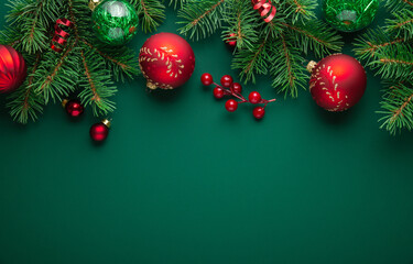 Christmas background with xmas tree, Christmas red ornament on green background. Merry Christmas greeting card. Winter holiday theme. Happy New Year. Xmas decoration