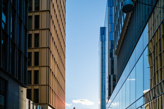A Stockholm skyline of urban architecture emerges through buildings in Hagastaden, where reflection and perspective define a facade unified by clear contemporary design language