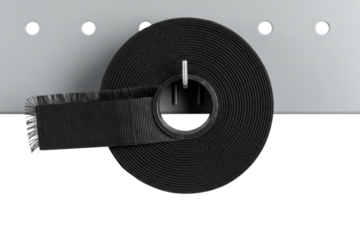 Black roll of hook and loop fastener tape on storage rack isolated on transparent background