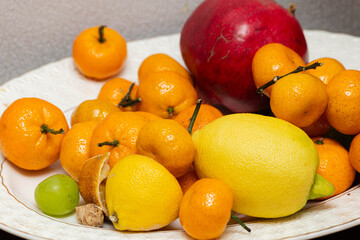 vibrant citrus display, colorful seasonal fruit arrangement, closeup of fresh citrus and pomegranates