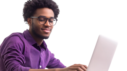 Young black man with glasses wearing a purple shirt smiling while typing on a silver laptop isolated on transparent background