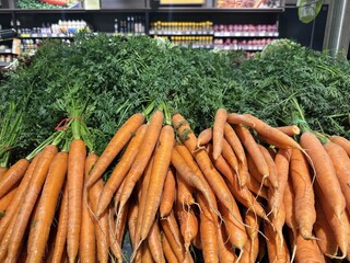 Fresh organic carrots displayed in a grocery store aisle food shopping carrots organic fresh produce vegetables