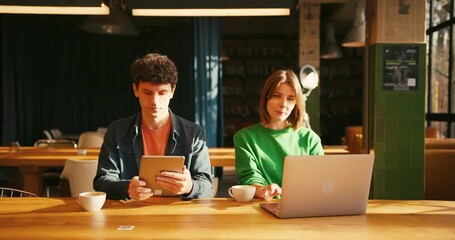 Young students collaborating on project in university library colleagues working in modern coworking - Powered by Adobe