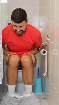 Embarrased man surprised by someone on the toilet 