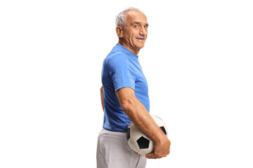 Mature man holding a football and turning towards camera