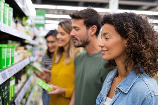 Diverse group of consumers examining eco-friendly products in store