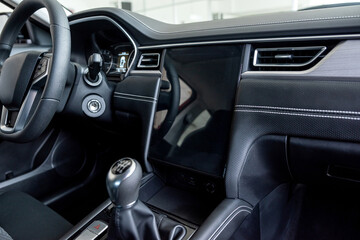 Fototapeta premium New modern car interior inside in modern showroom